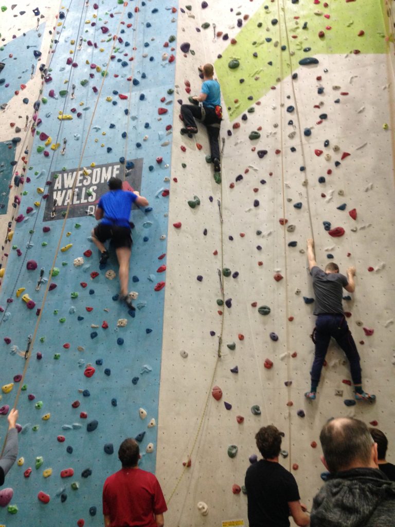 Three climbers scaling the 12 metre indoor wall at Awesome Walls, Dublin